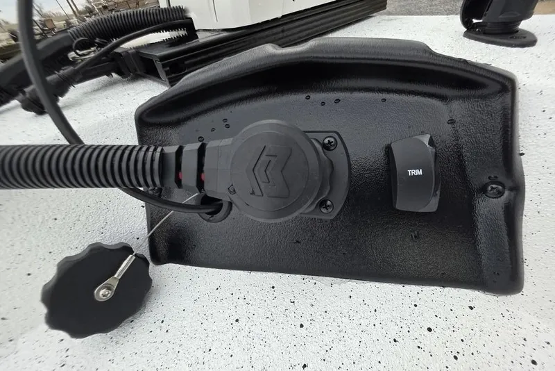 Slide: The Image of Close-up of 2026 Xpress H20B Bay boat trim control and wiring. - 20