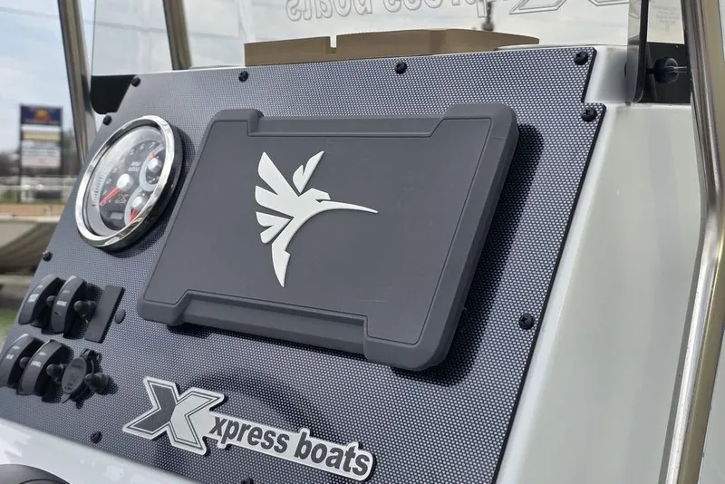 Slide: The Image of 2026 Xpress H20B Bay boat dashboard with logo and control panel. - 22