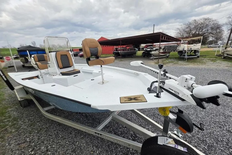 Slide: The Image of 2026 Xpress H20B Bay boat with Minn Kota trolling motor on trailer. - 23