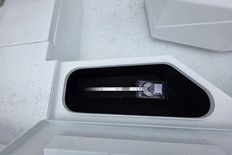 Slide: The Image of 2026 Xpress H20B Bay boat compartment with storage space and equipment. - 28