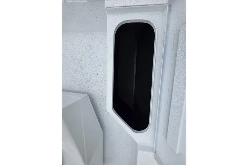 Slide: The Image of 2026 Xpress H20B Bay boat storage compartment, white interior with black opening. - 29