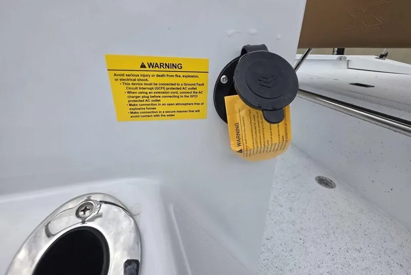 Slide: The Image of 2026 Xpress H20B Bay boat warning label and electrical outlet detail. - 30