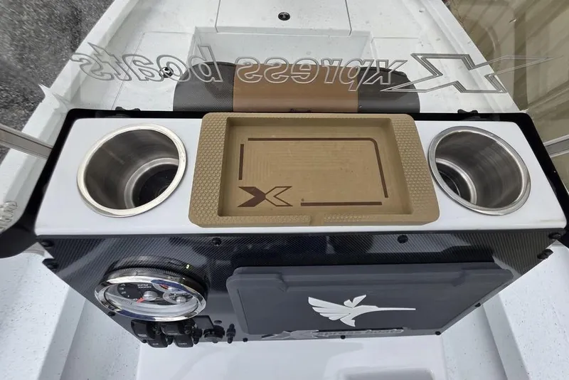 Slide: The Image of 2026 Xpress H20B Bay boat console with cup holders and storage tray. - 34