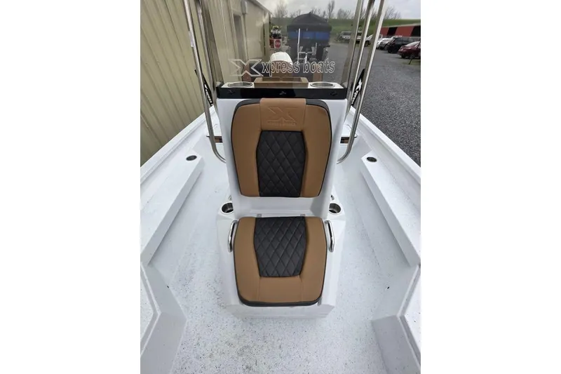 Slide: The Image of 2026 Xpress H20B Bay boat interior with dual tan and black seats. - 37