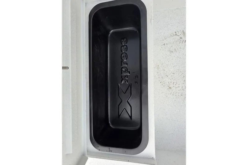Slide: The Image of 2026 Xpress H20B Bay boat compartment with embossed logo, black interior. - 38