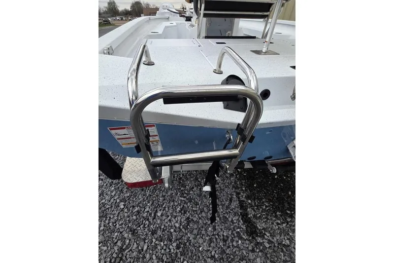 Slide: The Image of 2026 Xpress H20B Bay boat with stainless steel ladder on gravel surface. - 4