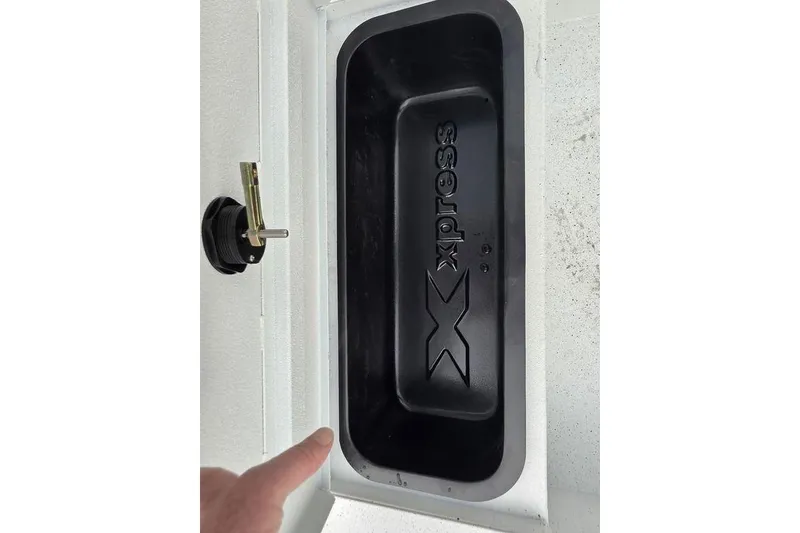 Slide: The Image of 2026 Xpress H20B Bay boat compartment with logo and latch detail. - 40