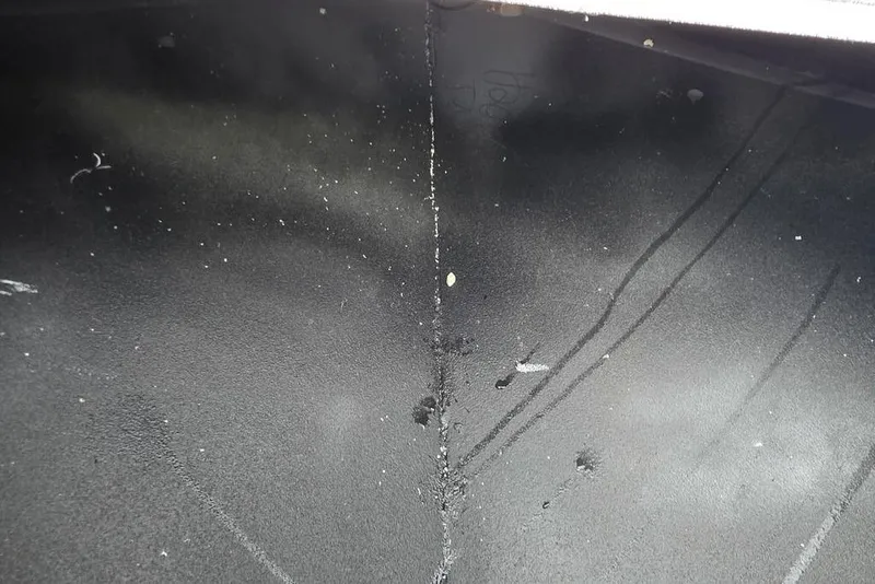 Slide: The Image of Close-up of 2026 Xpress H20B Bay boat surface with visible wear and scratches. - 41