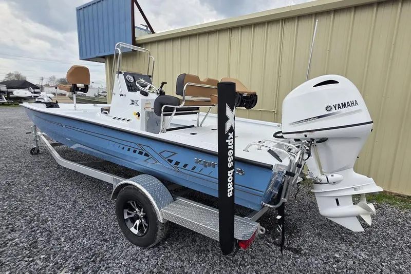 Slide: The Image of 2026 Xpress H20B Bay boat with Yamaha engine on trailer, parked outdoors. - 6