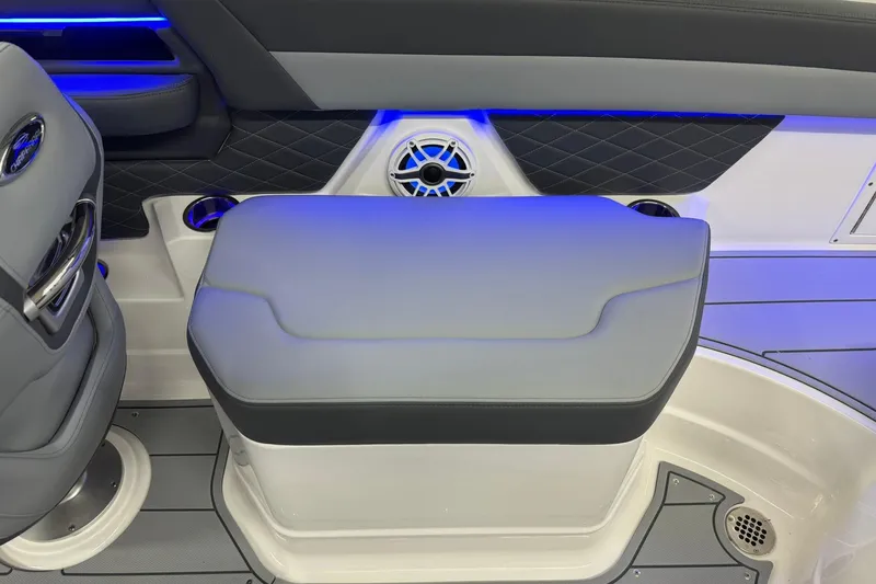 Slide: The Image of 2026 Chaparral SSX 6 boat interior with cushioned seating and blue LED lighting. - 28