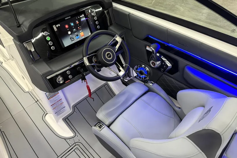 Slide: The Image of 2026 Chaparral SSX 6 boat cockpit with modern dashboard and steering wheel. - 13
