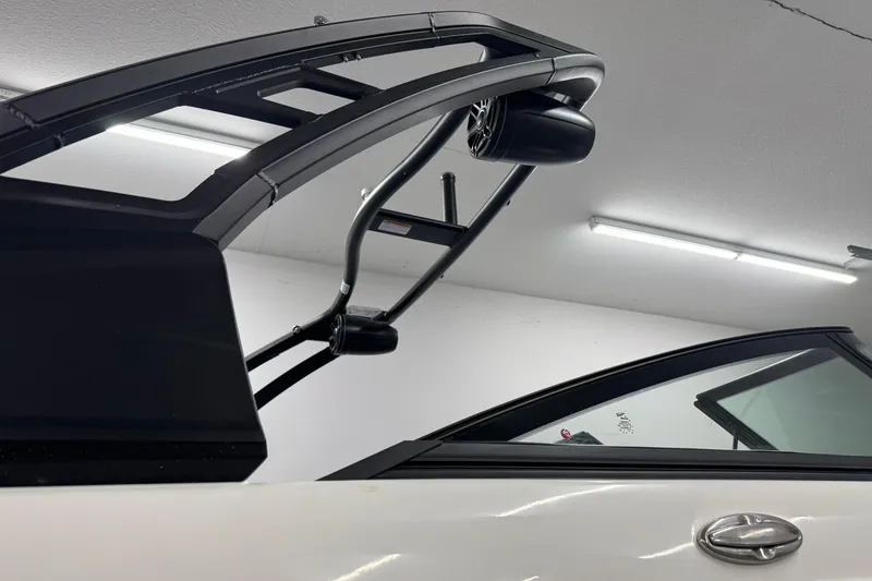 Slide: The Image of 2026 Chaparral SSX 6 boat with sleek design and modern features in a well-lit garage. - 41