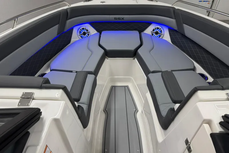 Slide: The Image of 2026 Chaparral SSX 6 boat interior with sleek seating and ambient blue lighting. - 35