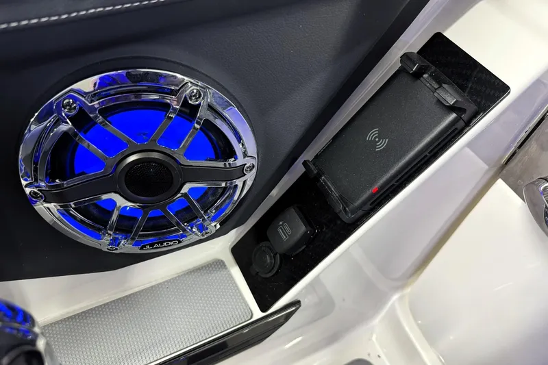 Slide: The Image of 2026 Chaparral SSX 6 boat interior with JL Audio speaker and wireless charging pad. - 23
