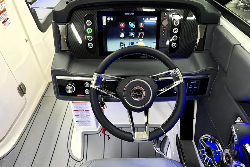 Slide: The Image of 2026 Chaparral SSX 6 boat dashboard with modern steering wheel and digital display. - 16