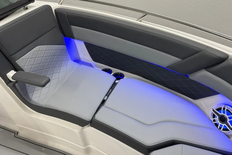 Slide: The Image of 2026 Chaparral SSX 6 boat interior with luxurious seating and ambient blue lighting. - 37