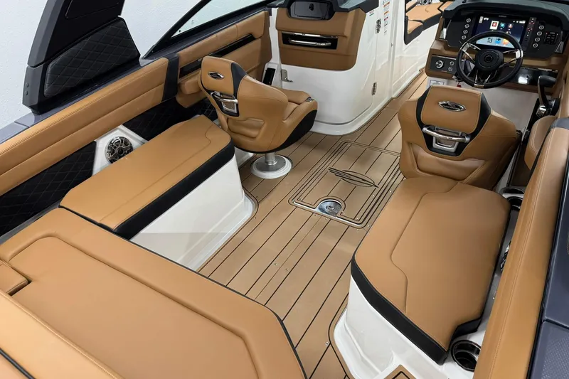 Slide: The Image of Luxurious interior of 2026 Chaparral SSX 6 boat with tan leather seating and modern dashboard. - 13