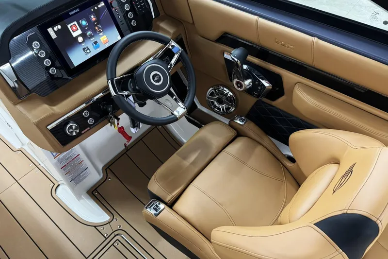 Slide: The Image of 2026 Chaparral SSX 6 boat interior with tan leather seats and modern dashboard. - 17