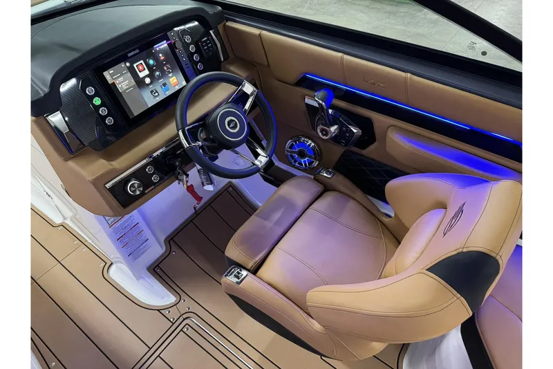 Slide: The Image of 2026 Chaparral SSX 6 boat cockpit with modern dashboard, touchscreen, and luxurious tan seating. - 18