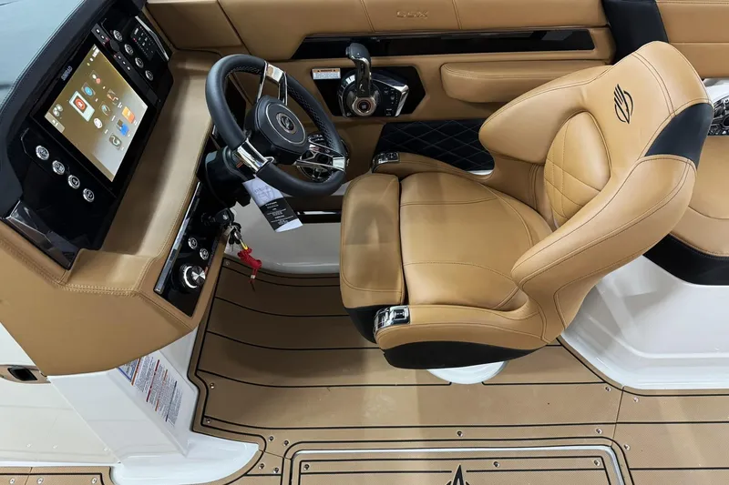 Slide: The Image of 2026 Chaparral SSX 6 boat interior with tan leather seating and modern dashboard controls. - 19