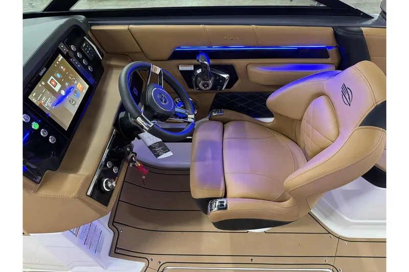 Slide: The Image of 2026 Chaparral SSX 6 boat interior with modern dashboard and luxurious tan seating. - 20