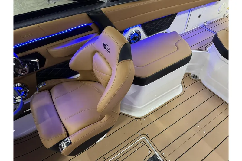 Slide: The Image of Luxurious interior of 2026 Chaparral SSX 6 boat with tan leather seating and blue LED lighting. - 23
