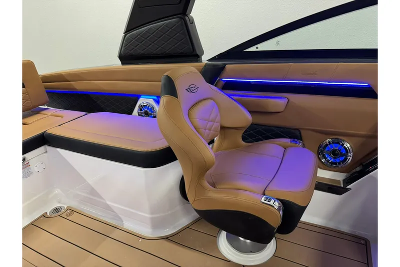 Slide: The Image of Luxurious interior of 2026 Chaparral SSX 6 boat with tan leather seating and blue LED lighting. - 30