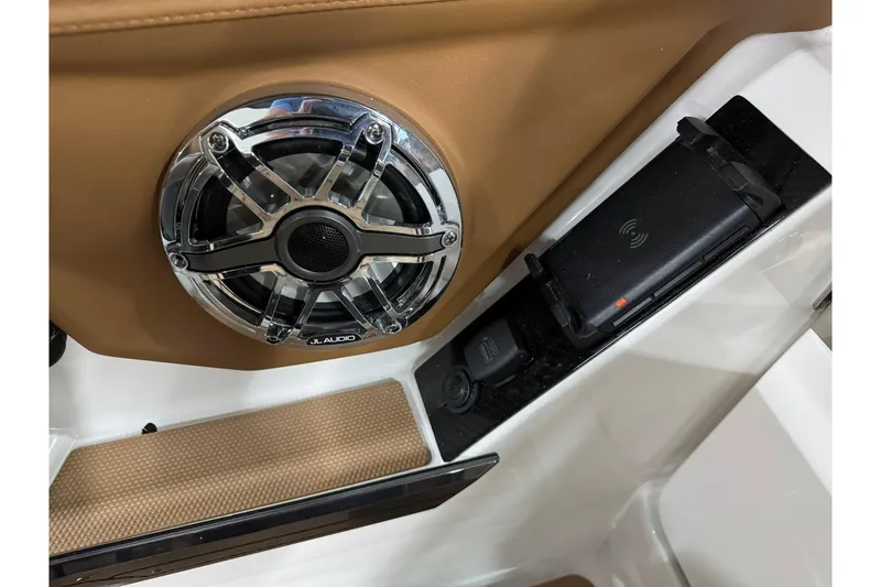 Slide: The Image of 2026 Chaparral SSX 6 boat interior with JL Audio speaker and wireless charging pad. - 31