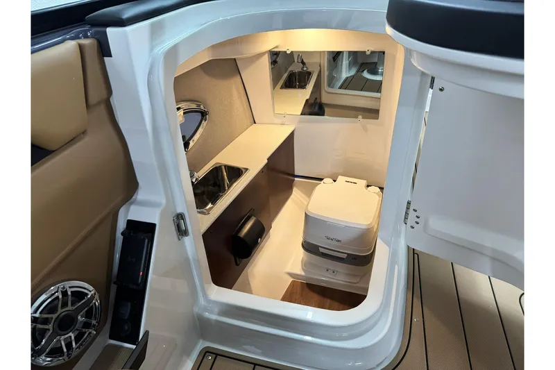 Slide: The Image of 2026 Chaparral SSX 6 boat interior with compact bathroom and modern amenities. - 32