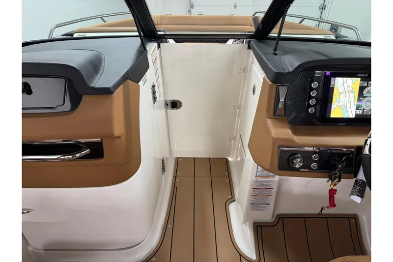 Slide: The Image of Interior view of 2026 Chaparral SSX 6 boat cockpit with navigation system and tan seating. - 36