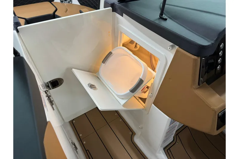 Slide: The Image of 2026 Chaparral SSX 6 boat interior with storage compartment and bucket. - 37
