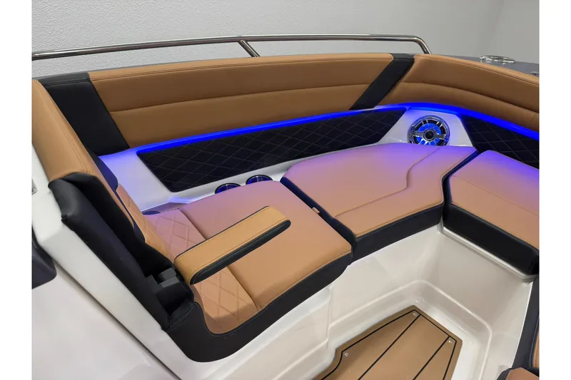 Slide: The Image of 2026 Chaparral SSX 6 boat interior with tan and black seating, blue LED lighting. - 42