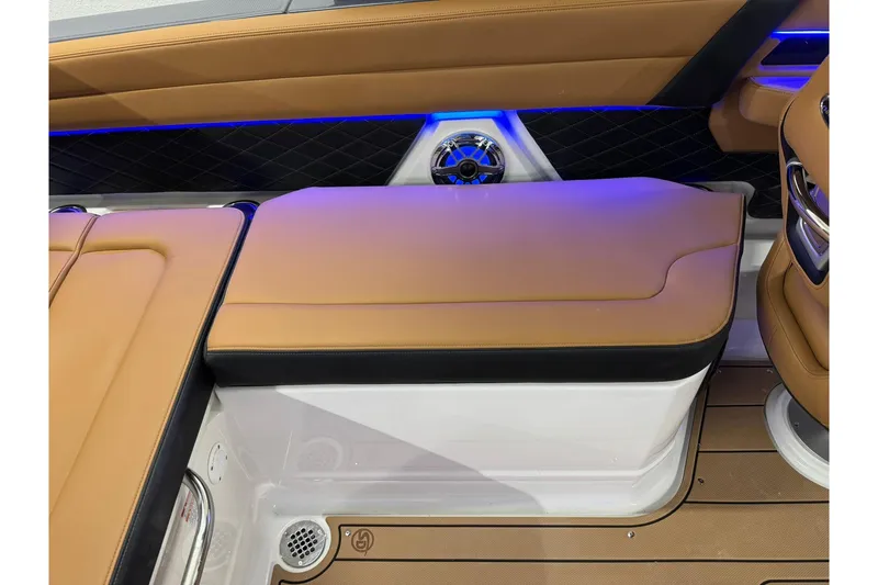 Slide: The Image of Luxurious interior seating of 2026 Chaparral SSX 6 boat with tan upholstery and blue LED lighting. - 47