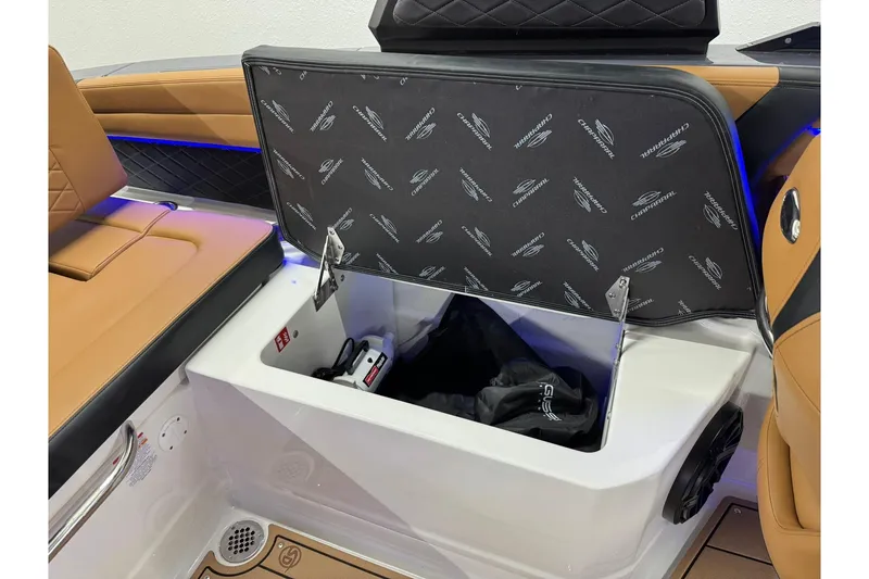 Slide: The Image of Open storage compartment in 2026 Chaparral SSX 6 boat with cushioned seating. - 48