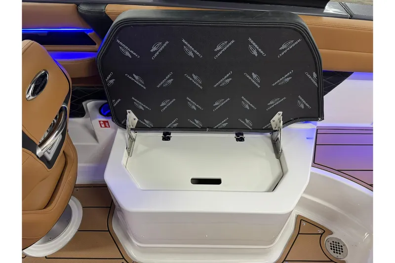 Slide: The Image of 2026 Chaparral SSX 6 boat interior storage compartment with open lid, showcasing sleek design. - 50