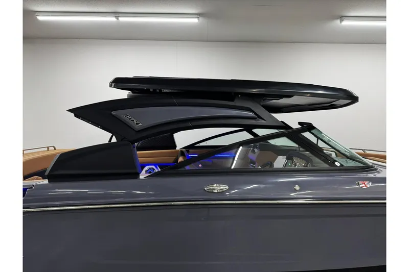 Slide: The Image of 2026 Chaparral SSX 6 boat with sleek design and modern features in a showroom setting. - 52