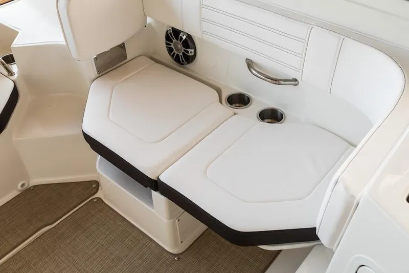 Slide: The Image of Manufacturer Provided Image: 2020 Sea Ray SPX 190 boat interior seating with cup holders and speaker. - 12