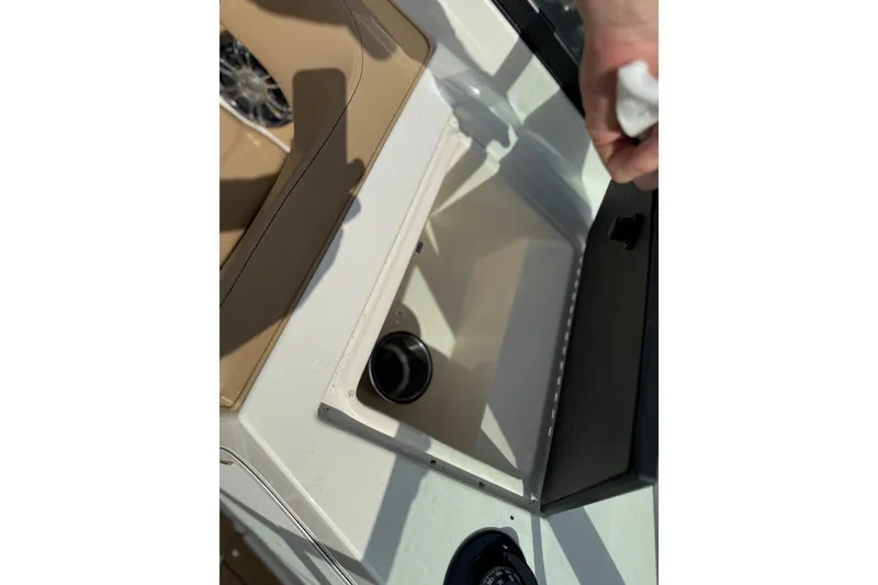 Slide: The Image of 2021 Sea Ray 19 SPX OB boat storage compartment with open lid. - 16