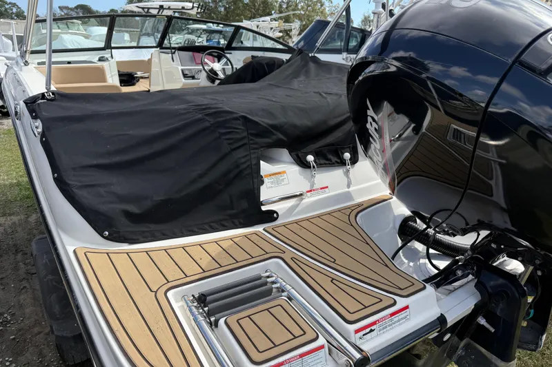 Slide: The Image of 2021 Sea Ray 19 SPX OB boat with covered seating and outboard motor. - 21
