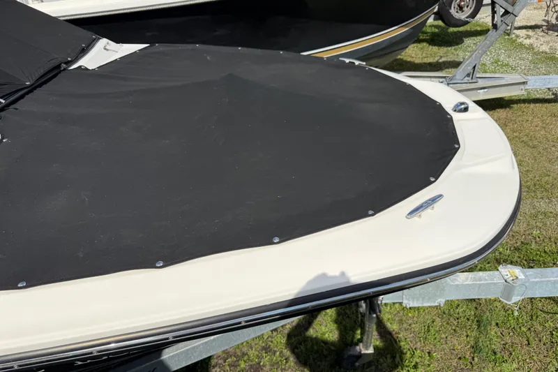 Slide: The Image of 2021 Sea Ray 19 SPX OB boat with black cover on trailer. - 23
