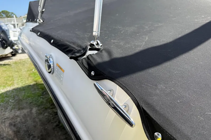 Slide: The Image of 2021 Sea Ray 19 SPX OB boat with black cover and chrome details. - 28