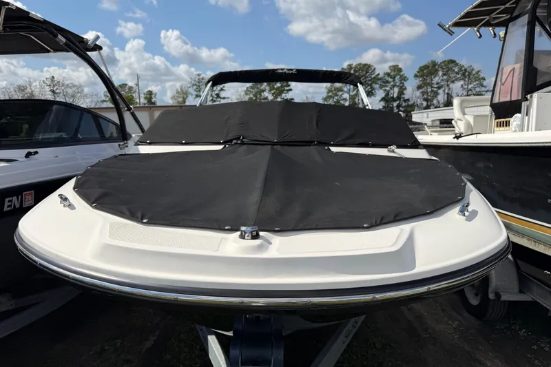 Slide: The Image of 2021 Sea Ray 19 SPX OB boat with black cover, parked outdoors under blue sky. - 29