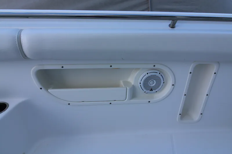 Slide: The Image of Interior detail of 2015 Boston Whaler 320 Outrage boat, featuring speaker and storage compartment. - 14