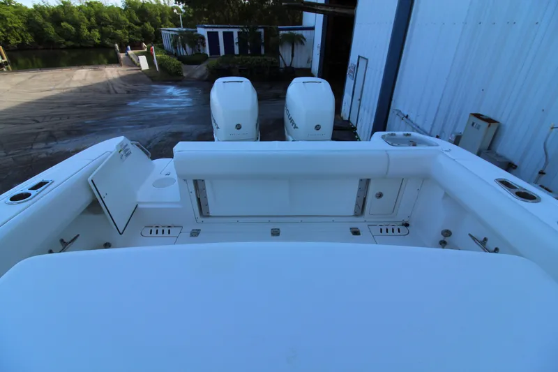 Slide: The Image of 2015 Boston Whaler 320 Outrage boat with dual outboard engines at dockside. - 19