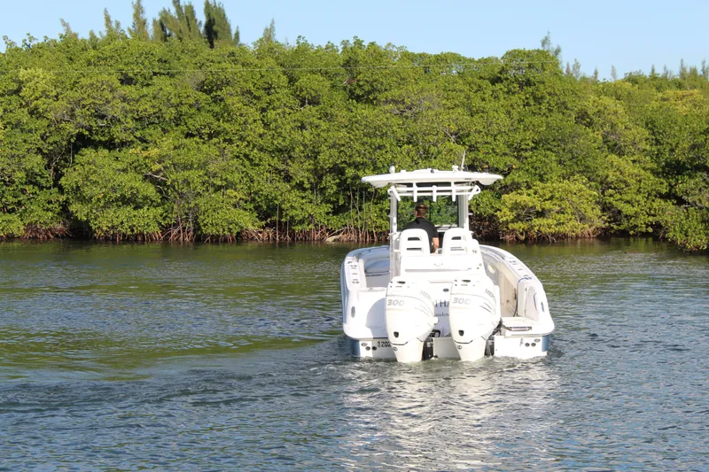 Slide: The Image of 2015 Boston Whaler 320 Outrage boat navigating through lush mangroves. - 26