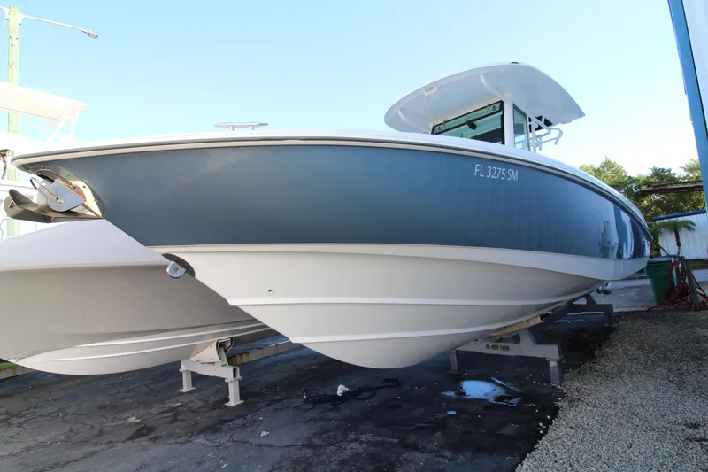 Slide: The Image of 2015 Boston Whaler 320 Outrage boat on display, side view. - 35