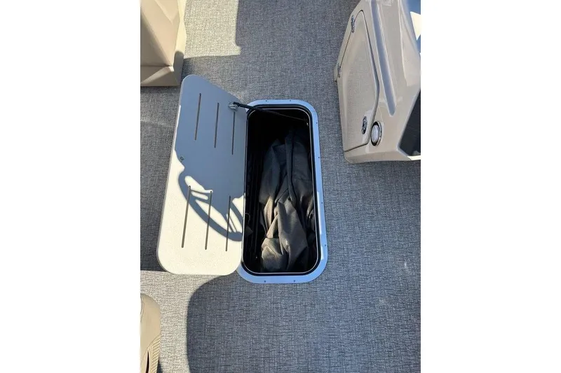 Slide: The Image of Open storage compartment on 2026 Bennington 22 S Quad Bench boat. - 6