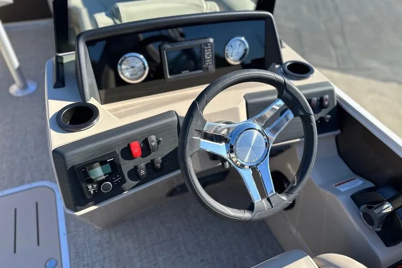 Slide: The Image of 2026 Bennington 22 S Quad Bench boat dashboard with steering wheel and controls. - 8