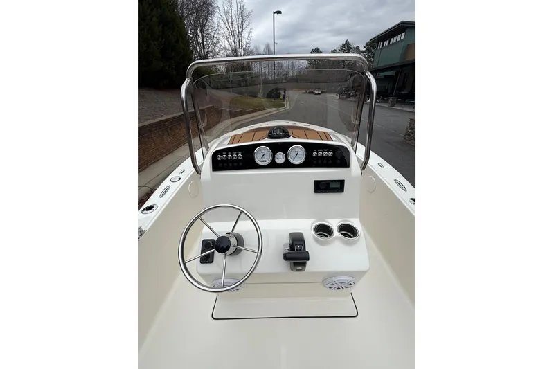 Slide: The Image of 2026 Pioneer 180 Islander boat dashboard with steering wheel and gauges. - 5