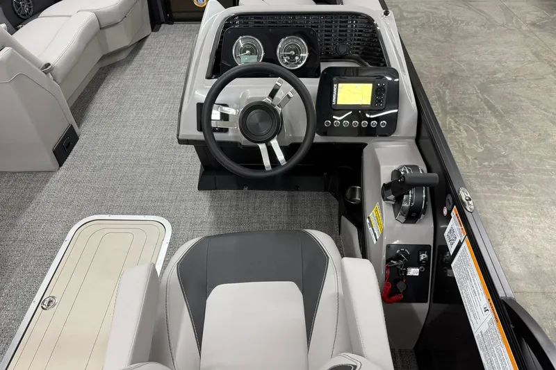 Slide: The Image of 2026 Barletta ARIA 22UC boat cockpit with steering wheel and navigation controls. - 10